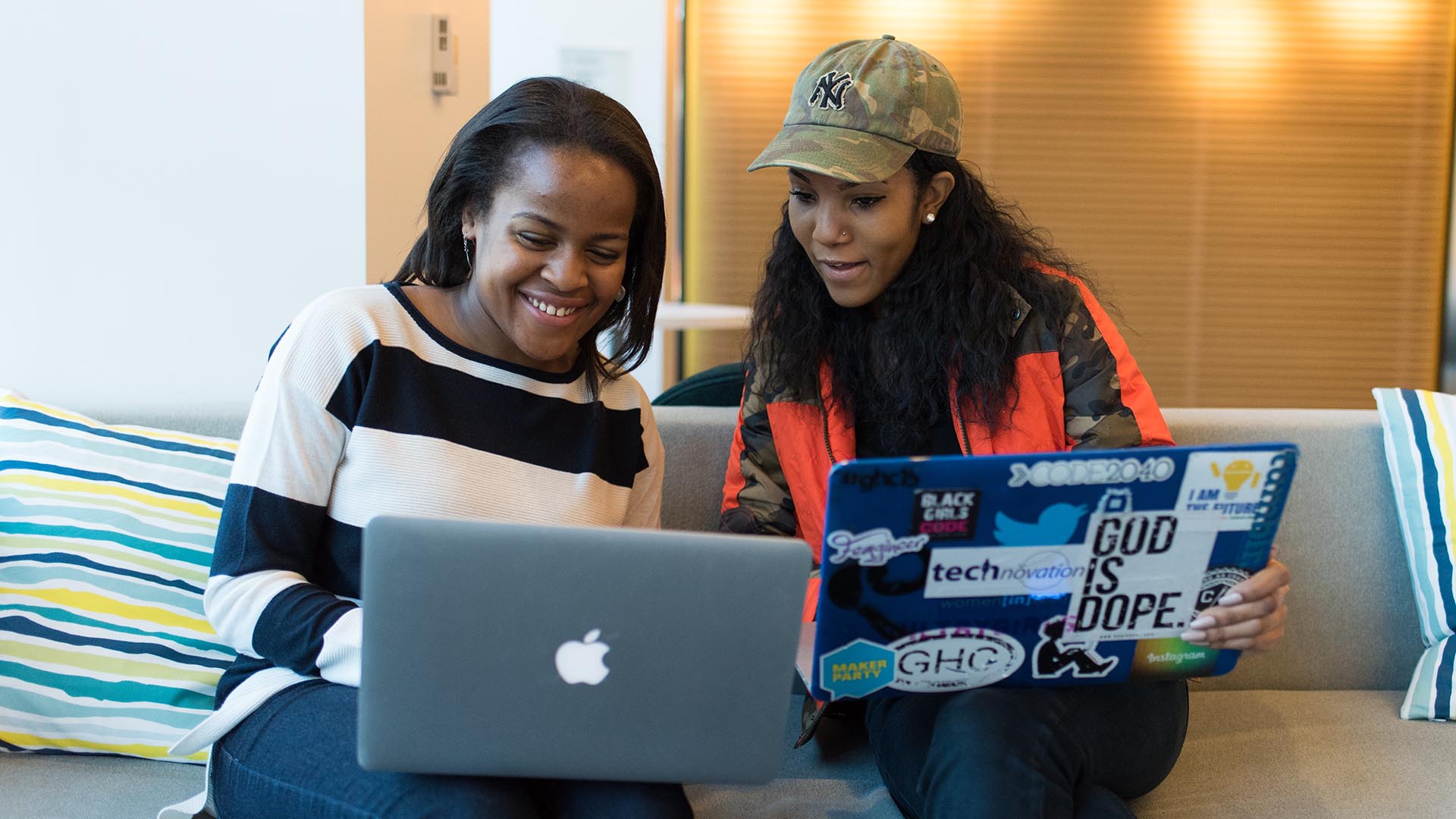 Photo of two black women using laptops